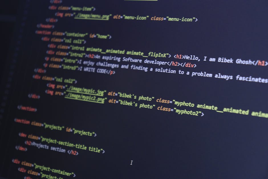 The image displays a close-up of a computer screen showing a coding interface with lines of programming code written in multiple colours on a dark background. The code includes syntax highlighting wit